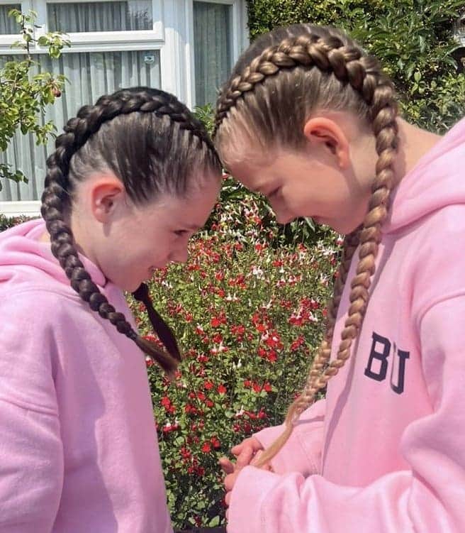 Matching boxer braids on two sisters