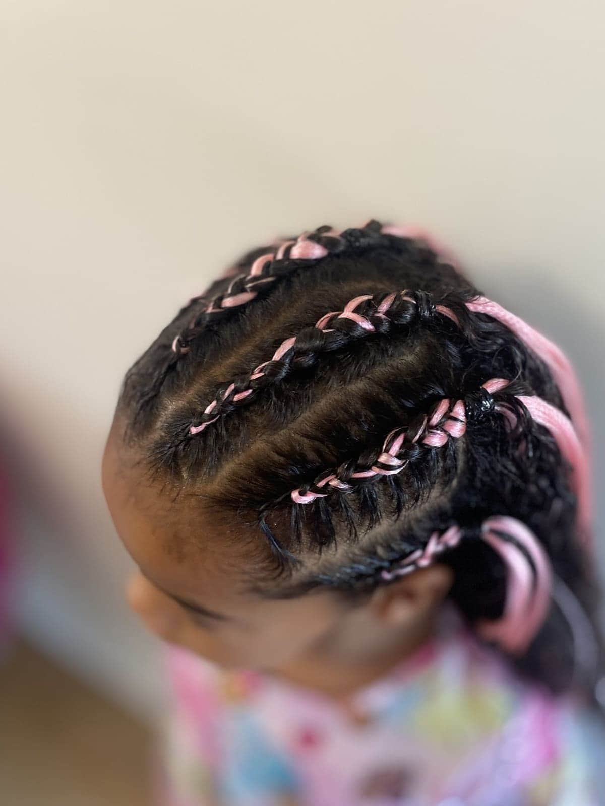Cornrows with pink hair pieces