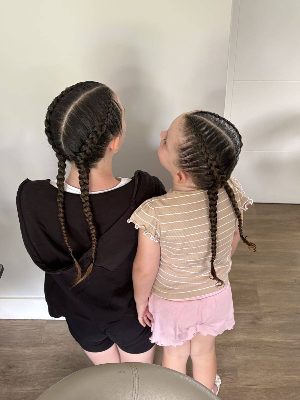 Two sisters with Dutch braids