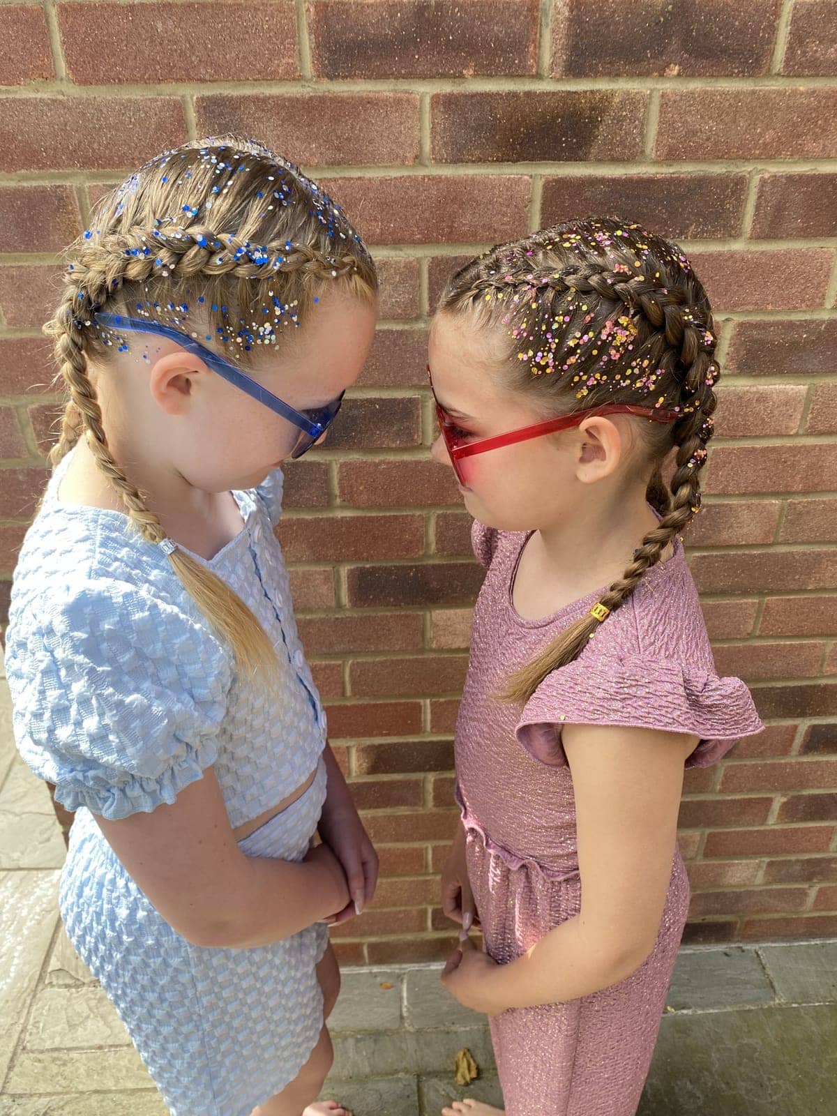 Two friends with glitter braids