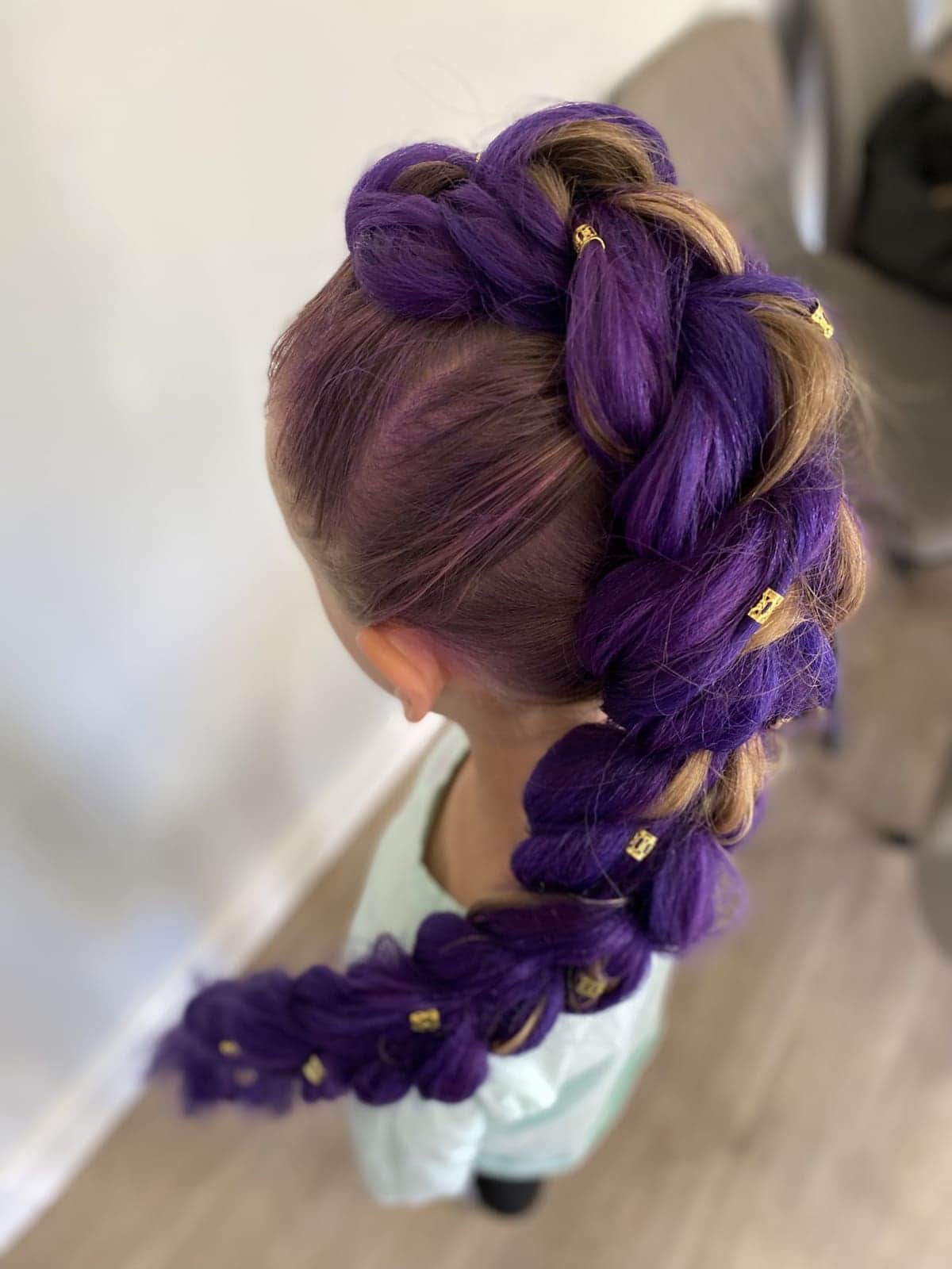 A purple Rumi braid with gold rings