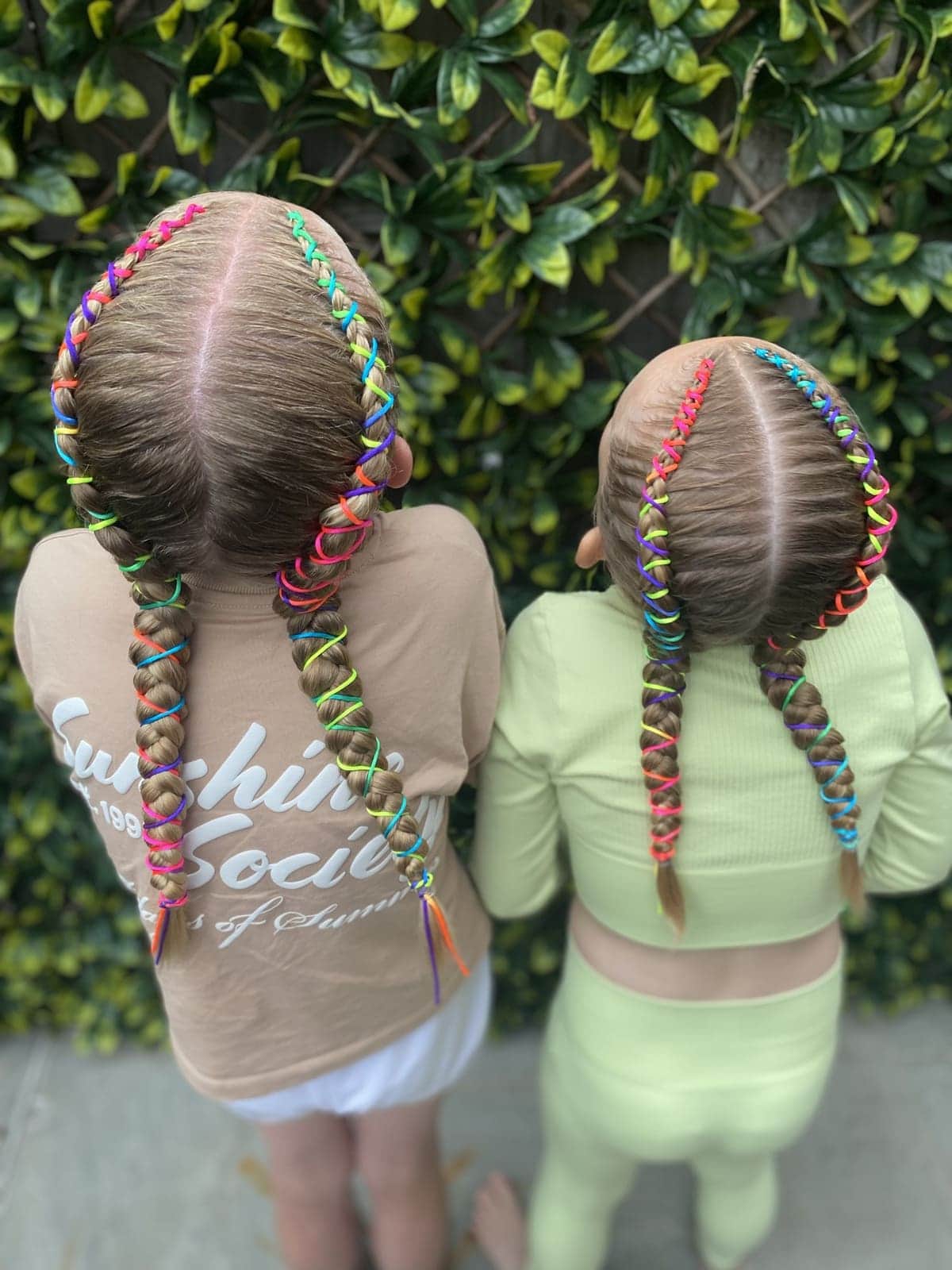Two girls with rainbow thread braids